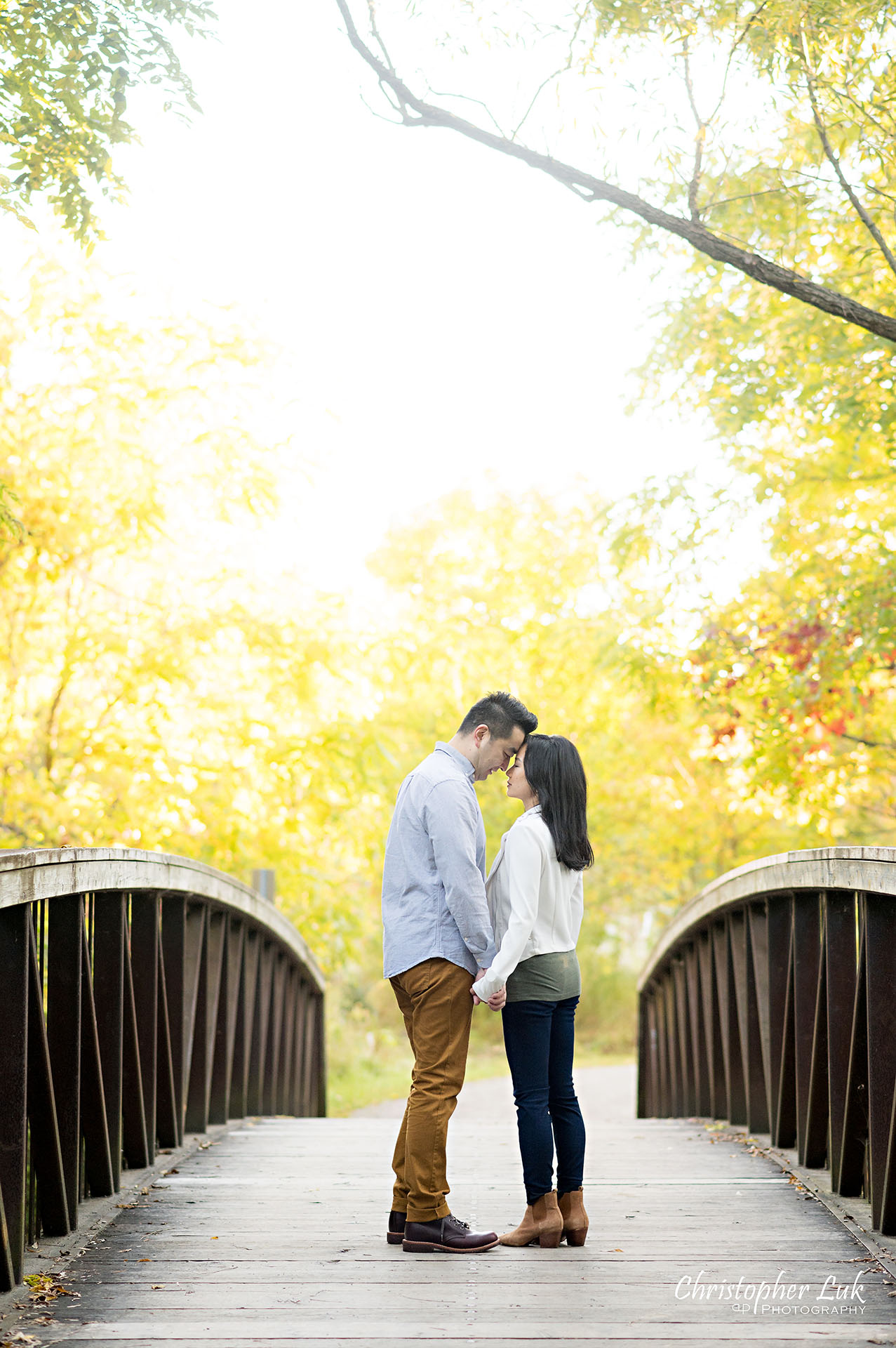 Mother Father Intimate Moment Together on Bridge Autumn Fall Leaves Markham Unionville Toronto Family Photographer