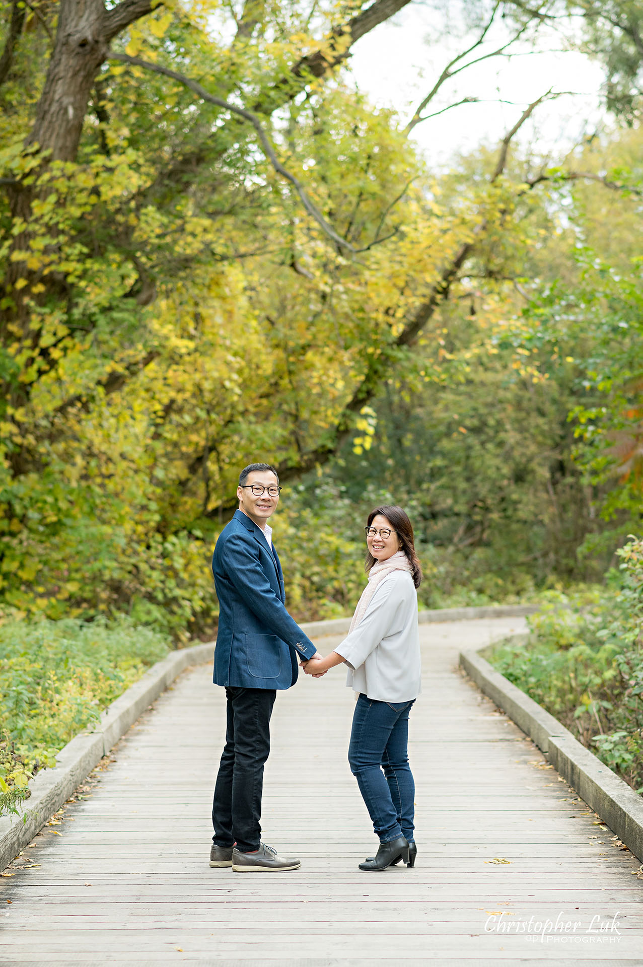 Father Mother Husband Wife Couple Holding Hands Walking Together Smile Portrait Main Street Unionville Markham Boardwalk Forest Toronto Family Photographer