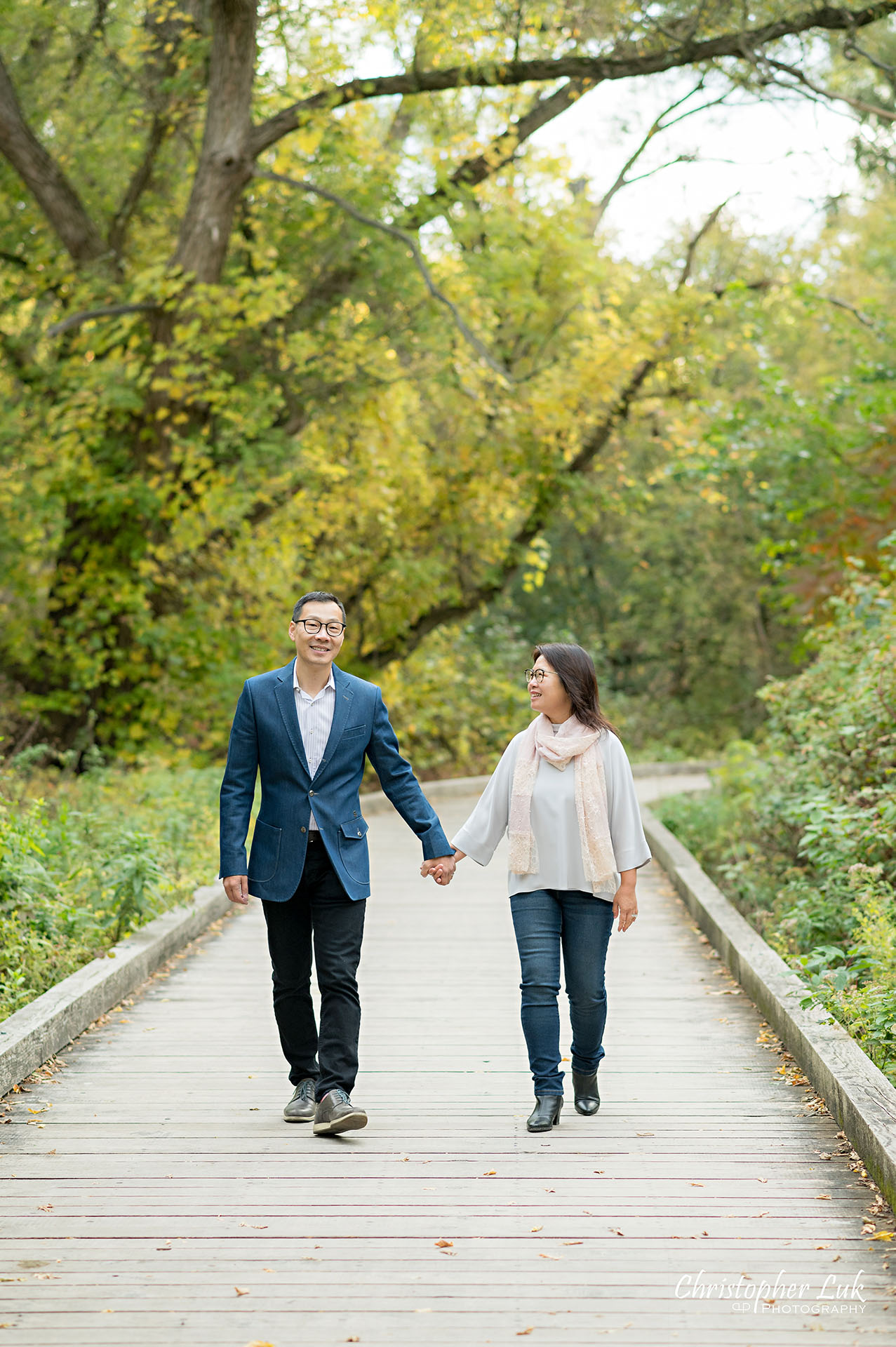 Father Mother Husband Wife Couple Holding Hands Walking Together Happy Portrait Main Street Unionville Markham Boardwalk Forest Toronto Family Photographer