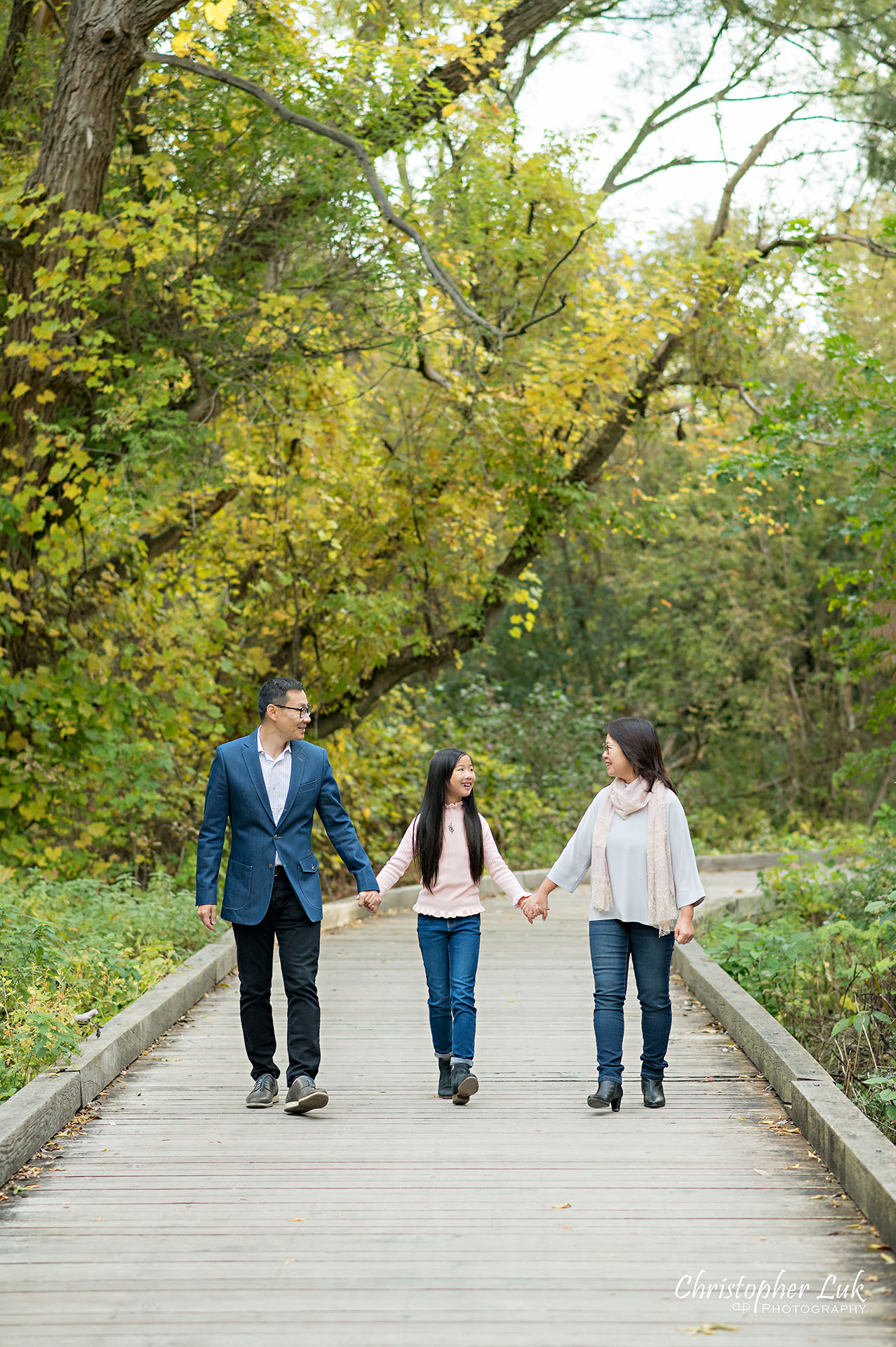 Father Mother Holding Hands Walking Together with Daughter Fun Main Street Unionville Markham Boardwalk Forest Toronto Family Photographer