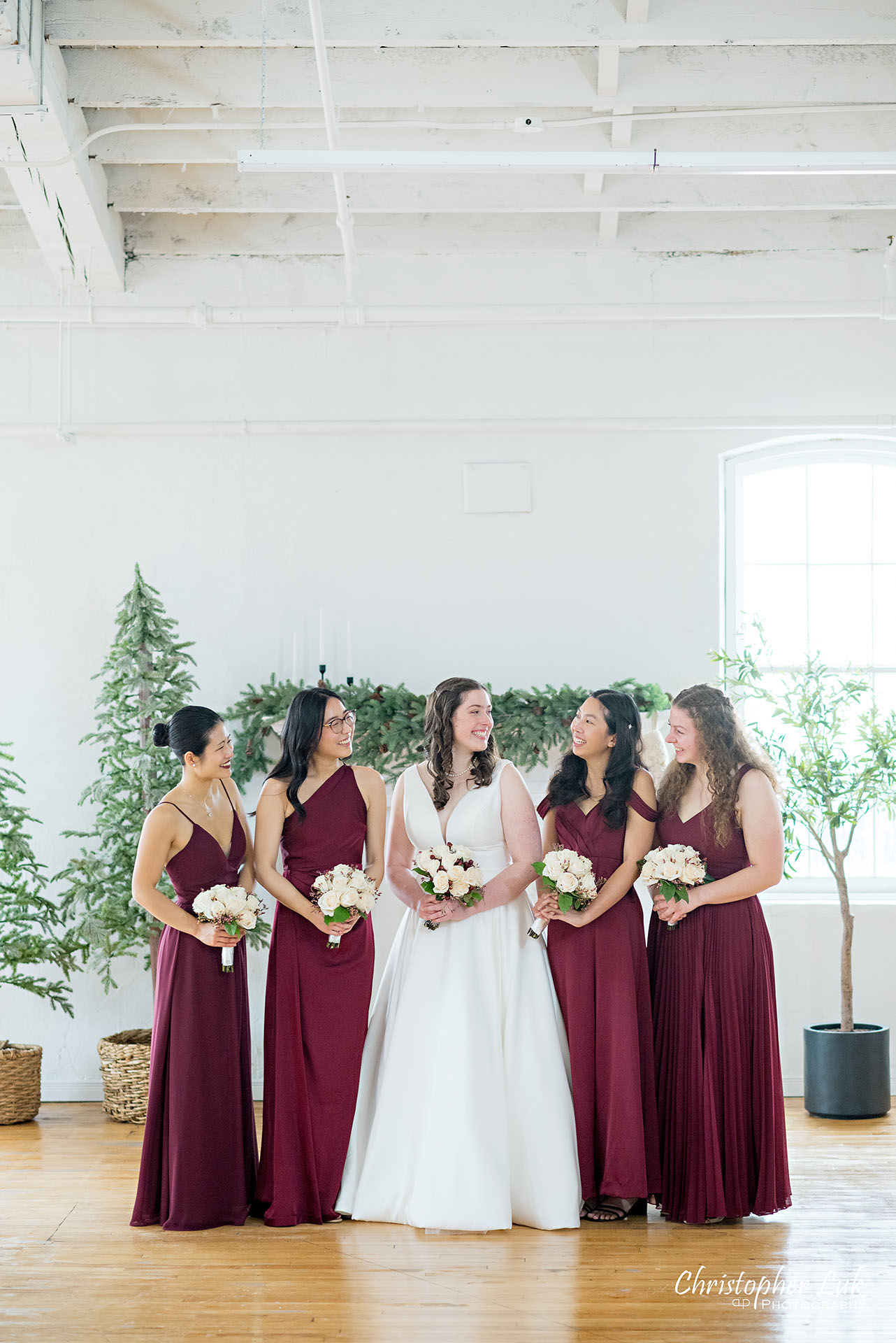 Wedding Party Bridal Bride Bridesmaids Red Dresses Gowns Group Photo Vintage White Loft Studio Kitchener Waterloo Winter Christmas Portrait Natural Candid Photojournalistic Happy
