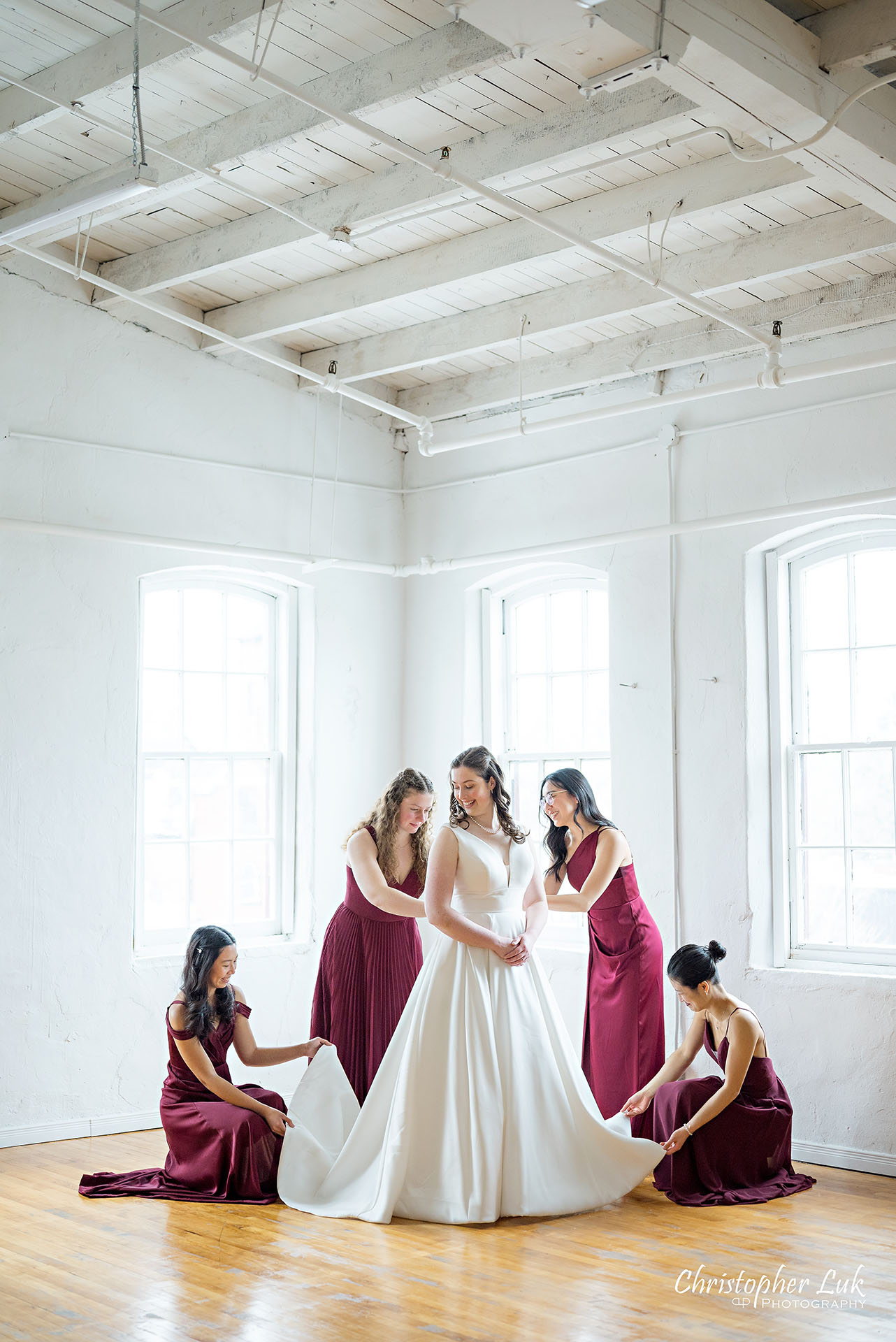 Wedding Party Bridal Getting Ready Bride Bridesmaids Red Dresses Gowns Group Photo Vintage White Loft Studio Kitchener Waterloo Winter Christmas Portrait Natural Candid Photojournalistic Happy Smile