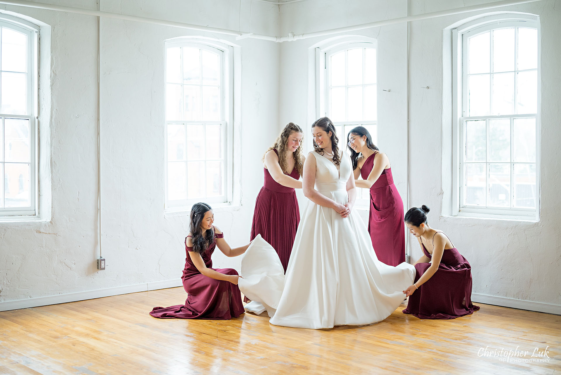 Wedding Party Bridal Getting Ready Bride Bridesmaids Red Dresses Gowns Group Photo Vintage White Loft Studio Kitchener Waterloo Winter Christmas Landscape Natural Candid Photojournalistic Happy Smile