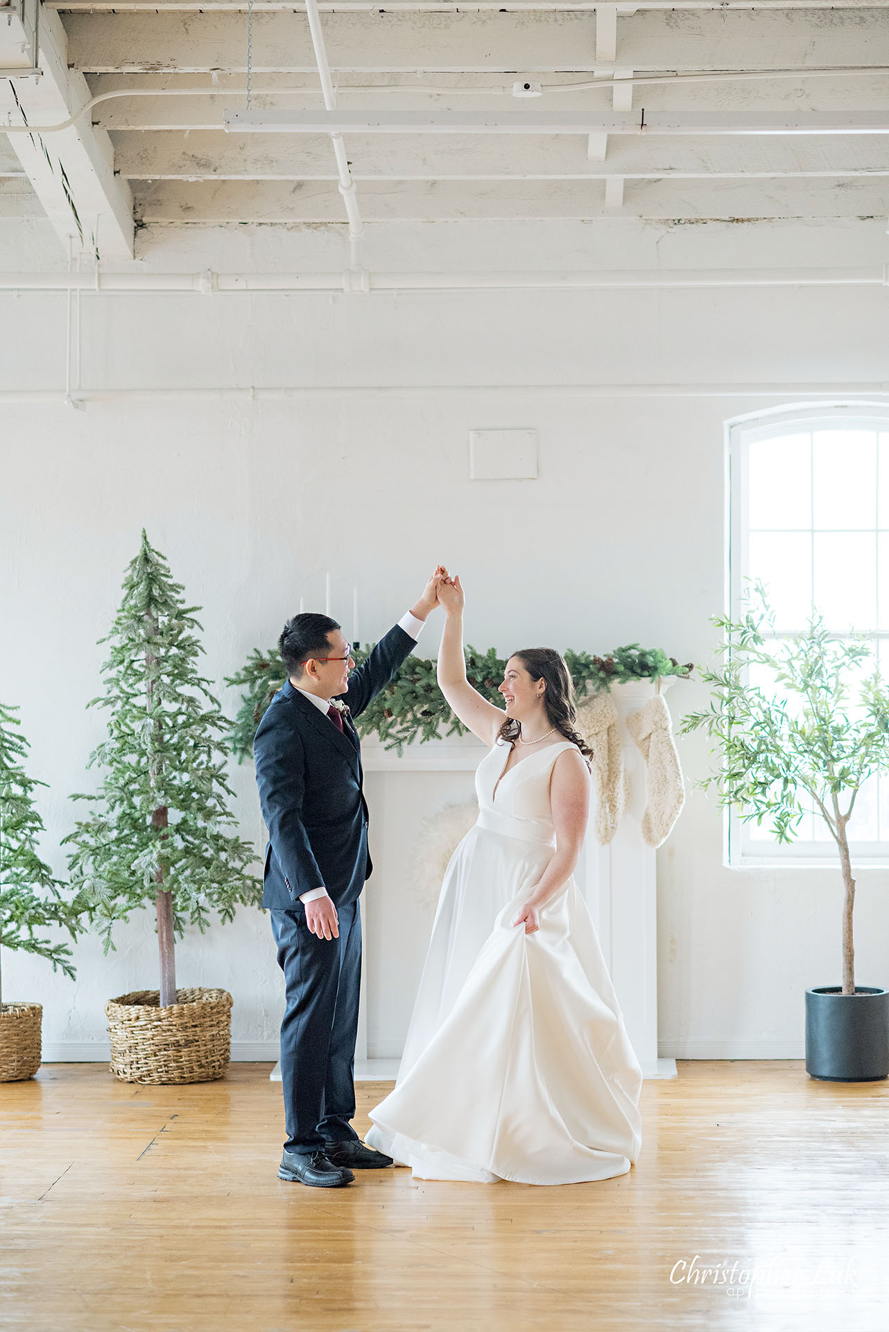 Bride Groom Vintage White Loft Studio Kitchener Waterloo Winter Christmas Natural Candid Photojournalistic Happy Smile Hug Hold Each Other Portrait Bridal Gown Dress Train Dancing Twirl Spin