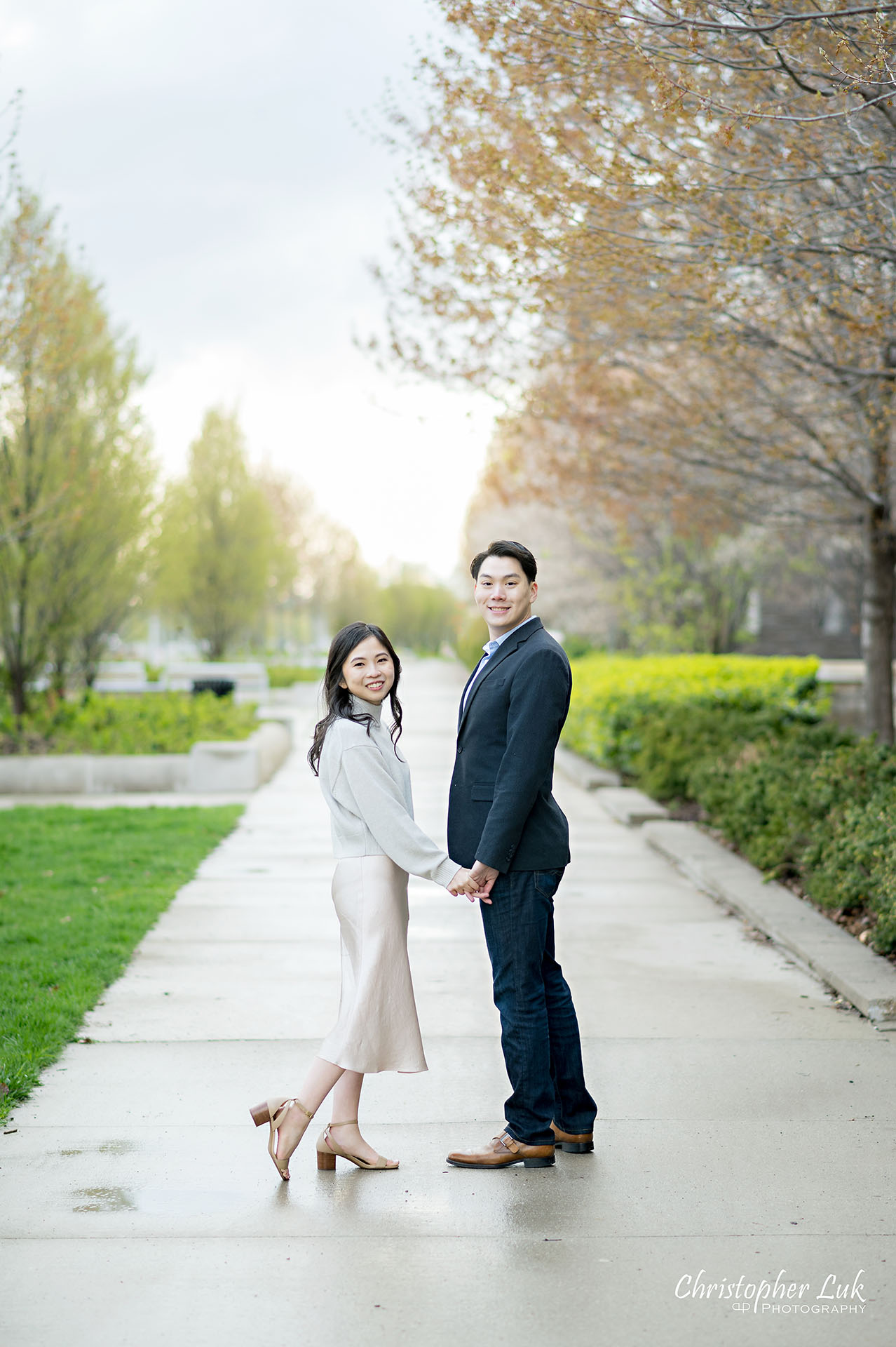 Bride Groom Engagement Session Candid Natural Organic Photojournalistic Holding Hands Walking Together Path Looking Camera Smile