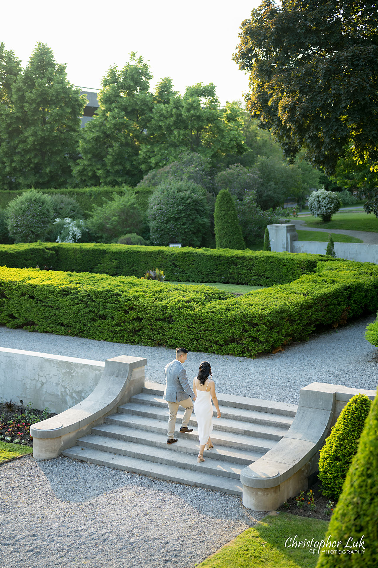 Parkwood Estate Bride Groom Engagement Session Formal Gardens Holding Hands Walking Together Stairs Portrait 