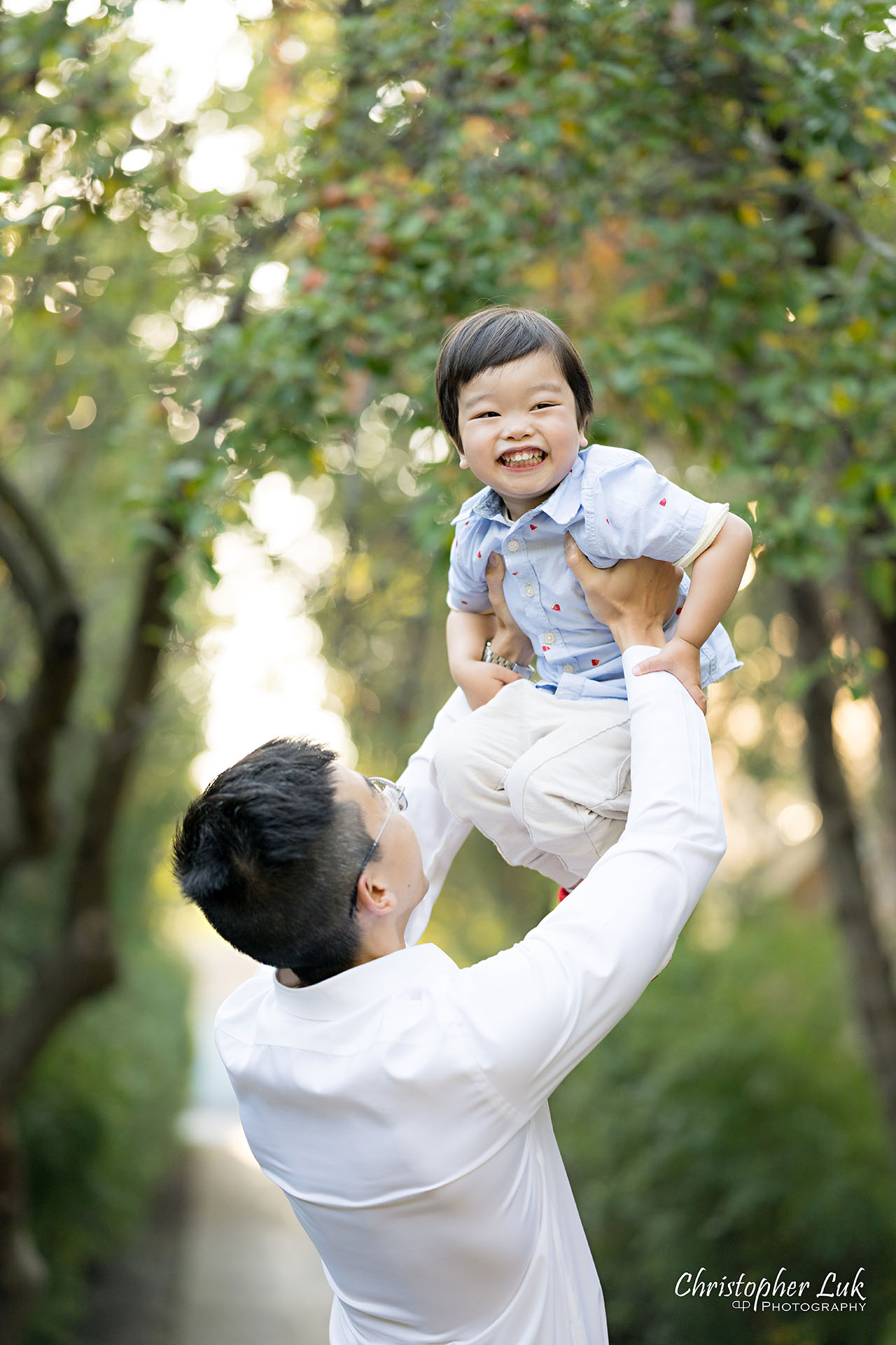 Christopher Luk Markham Family Photographer Photojournalistic Candid Natural Organic Father Son Fun Laughing Play Flying Portrait