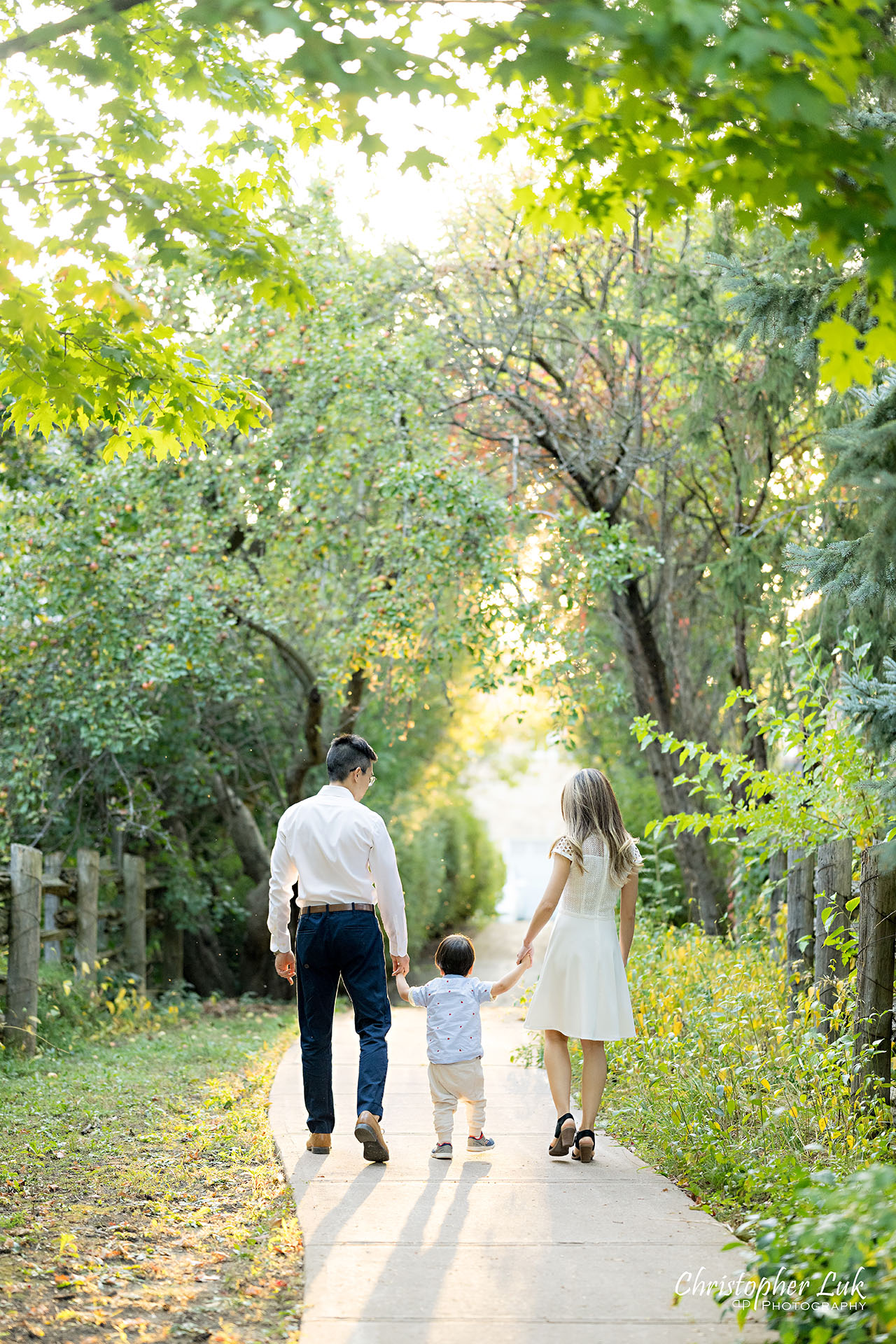 Christopher Luk Markham Family Photographer Photojournalistic Candid Natural Organic Husband Wife Mom Dad Son Child Family Holding Hands Walking Together Portrait