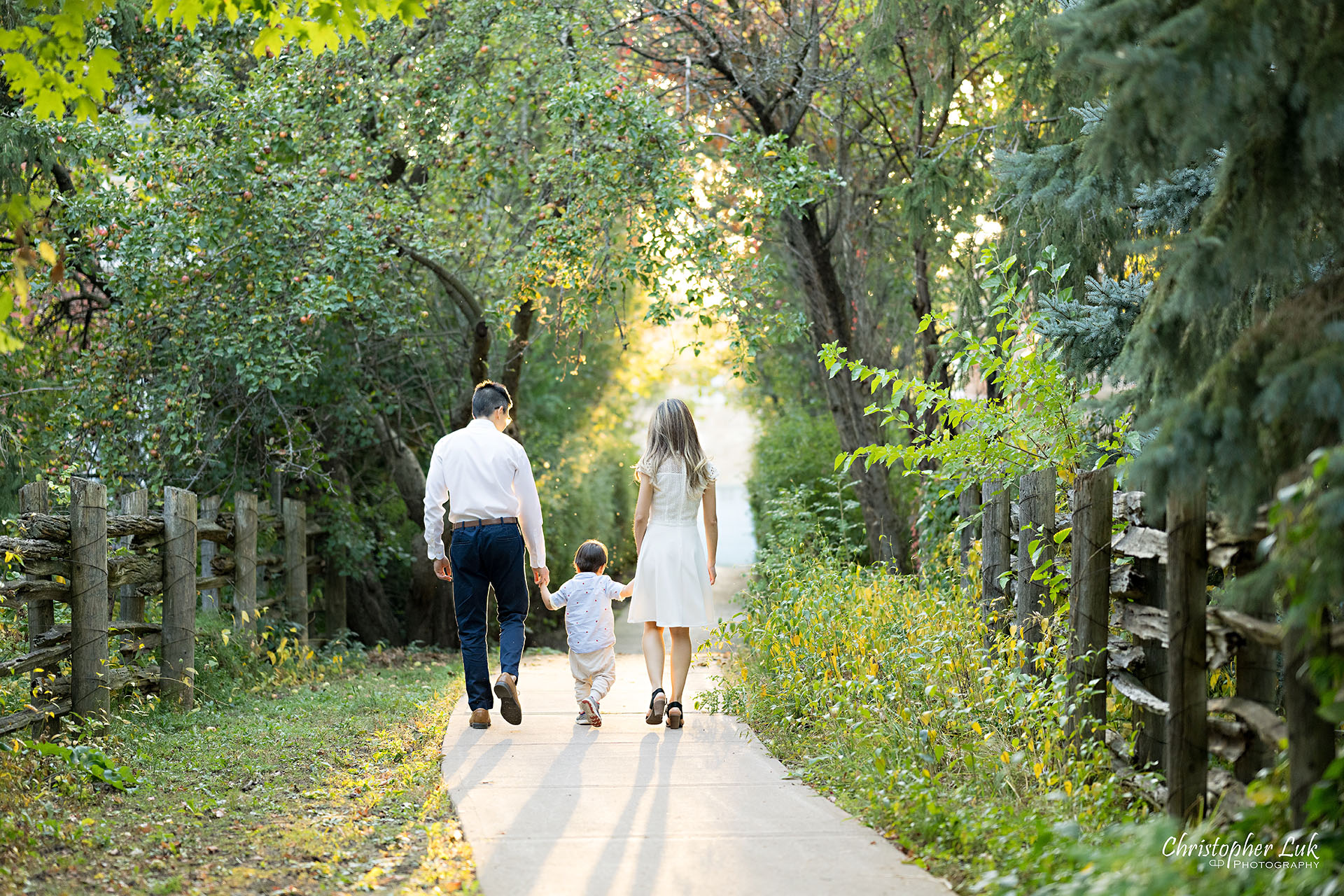 Christopher Luk Markham Family Photographer Photojournalistic Candid Natural Organic Husband Wife Mom Dad Son Child Family Holding Hands Walking Together