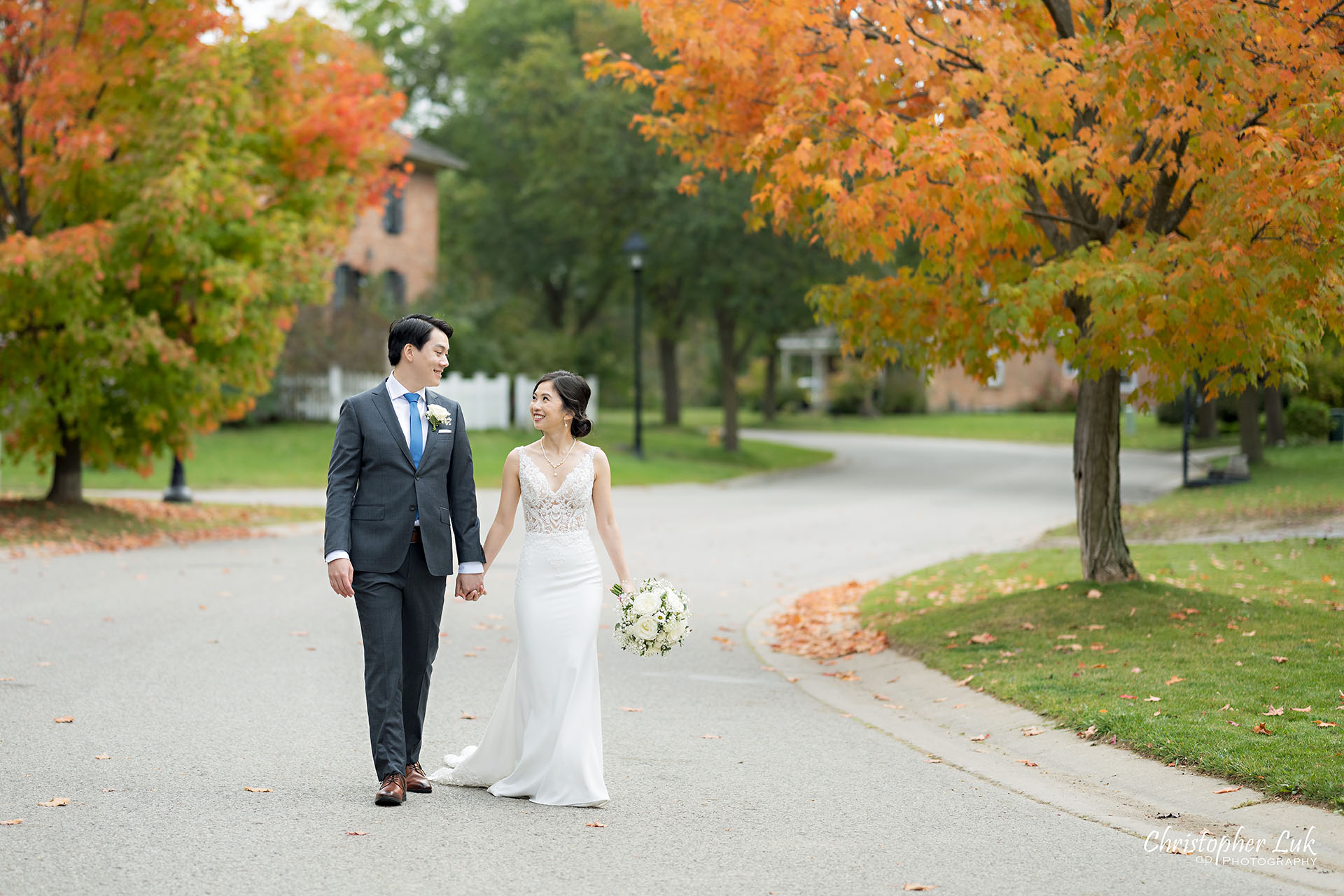 Bride Groom Wedding Autumn Fall Leaves Holding Hands Walking Together Candid Natural Organic Photojournalistic Landscape Streetscape