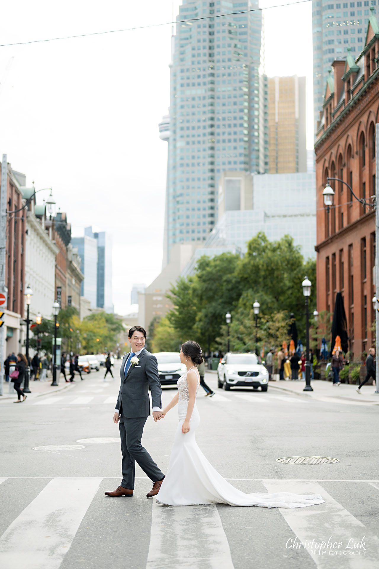 Bride Groom Wedding Holding Hands Walking Together Candid Natural Organic Photojournalistic Streetscape Downtown Toronto Front Street St Lawrence Market Architecture Street Road Crosswalk Portrait