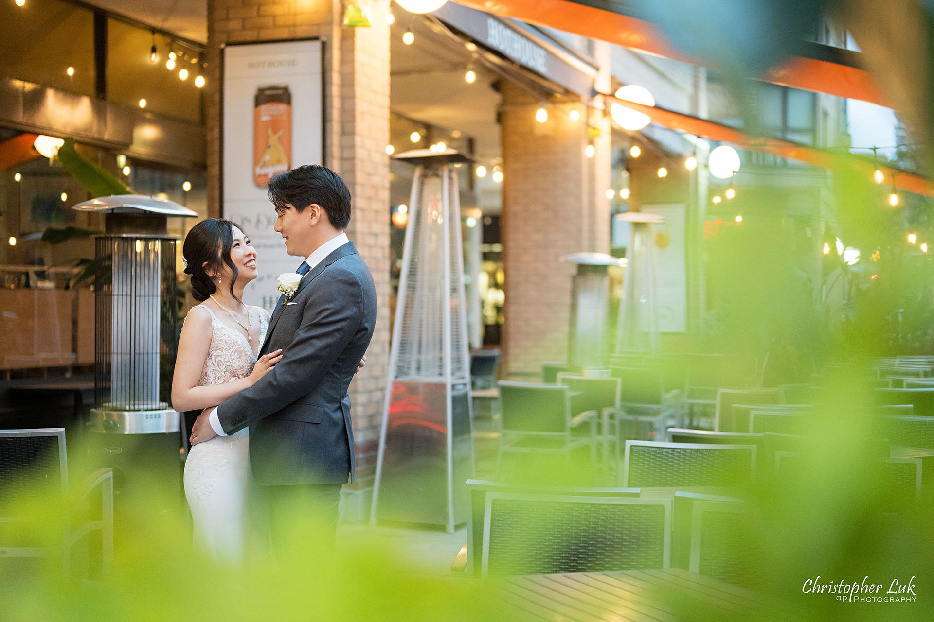 HotHouse Restaurant Wedding Main Entrance Exterior Patio Seating Bride Groom Twinkling String Lights Hugging Holding Each Other