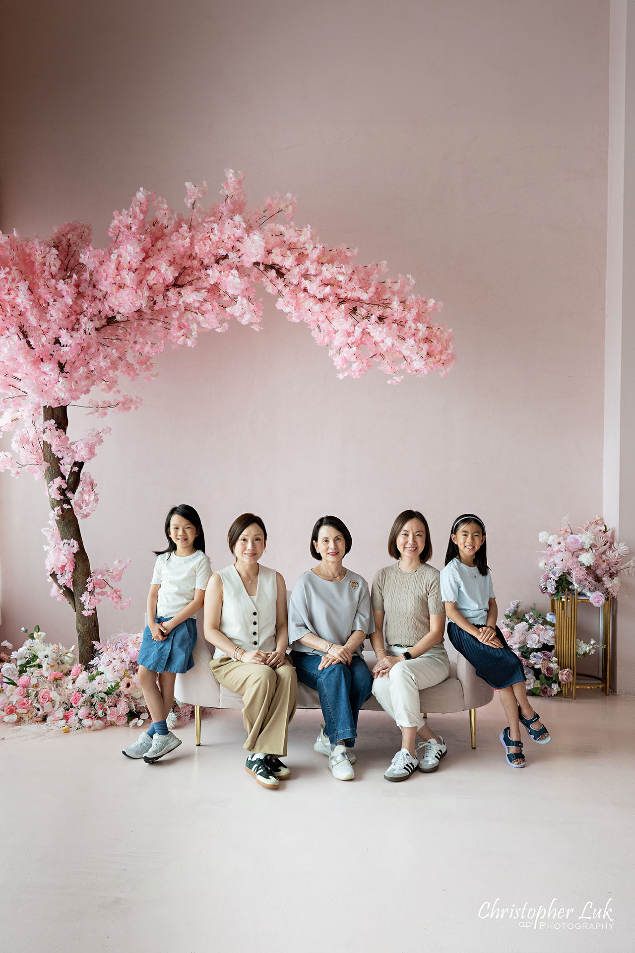 Grandmother Mothers Sisters Daughters Women Family Together Under a Pink Cherry Blossom Tree