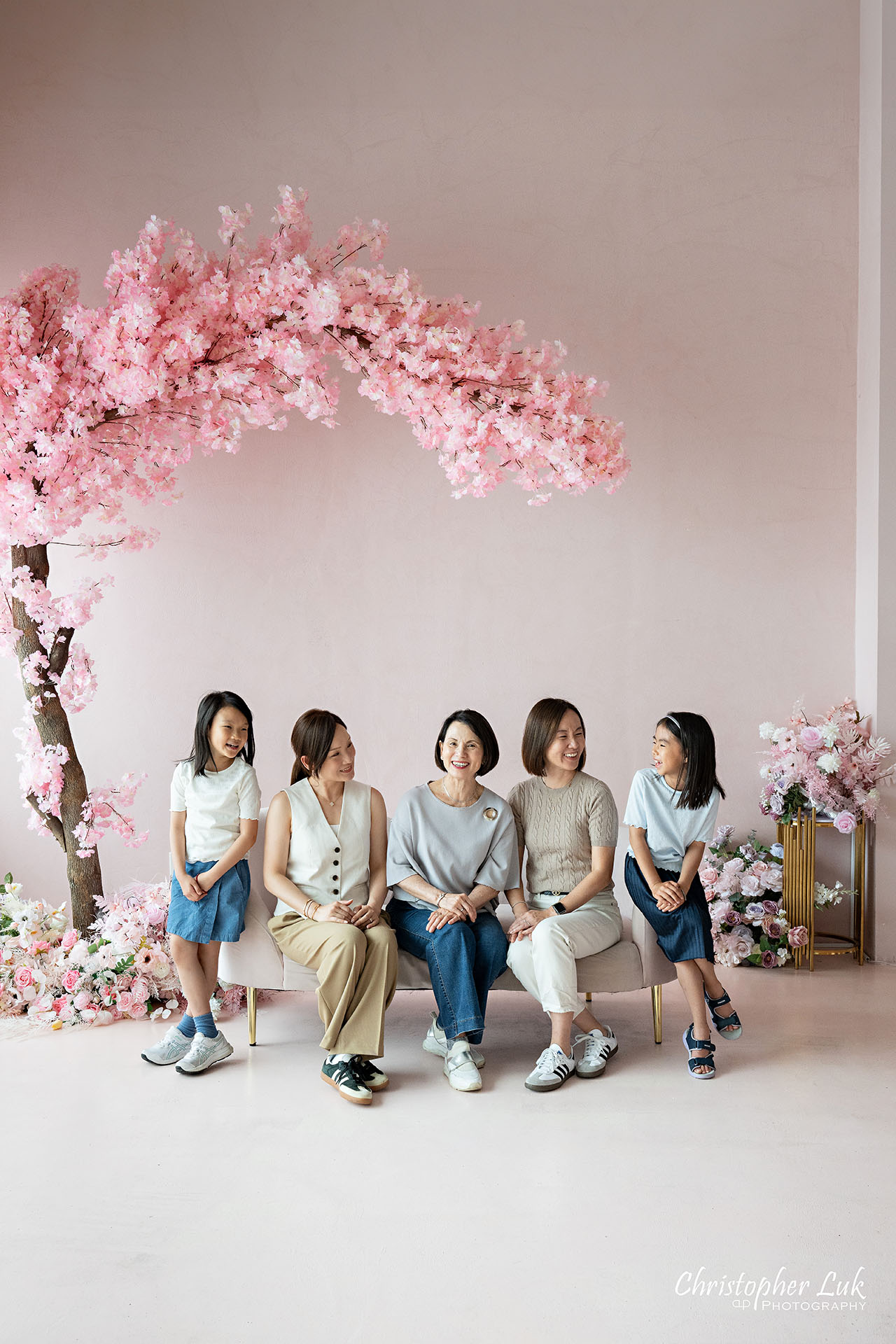 Grandmother Mothers Sisters Daughters Women Family Together Under a Pink Cherry Blossom Tree Candid Natural Organic Photojournalistic