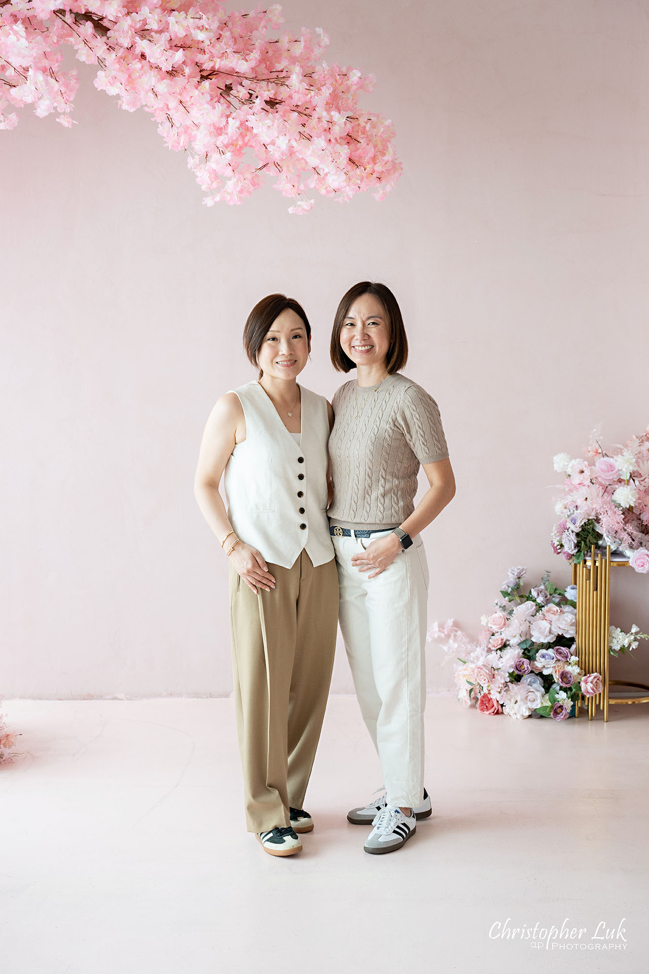 Sisters Together Under a Pink Cherry Blossom Tree