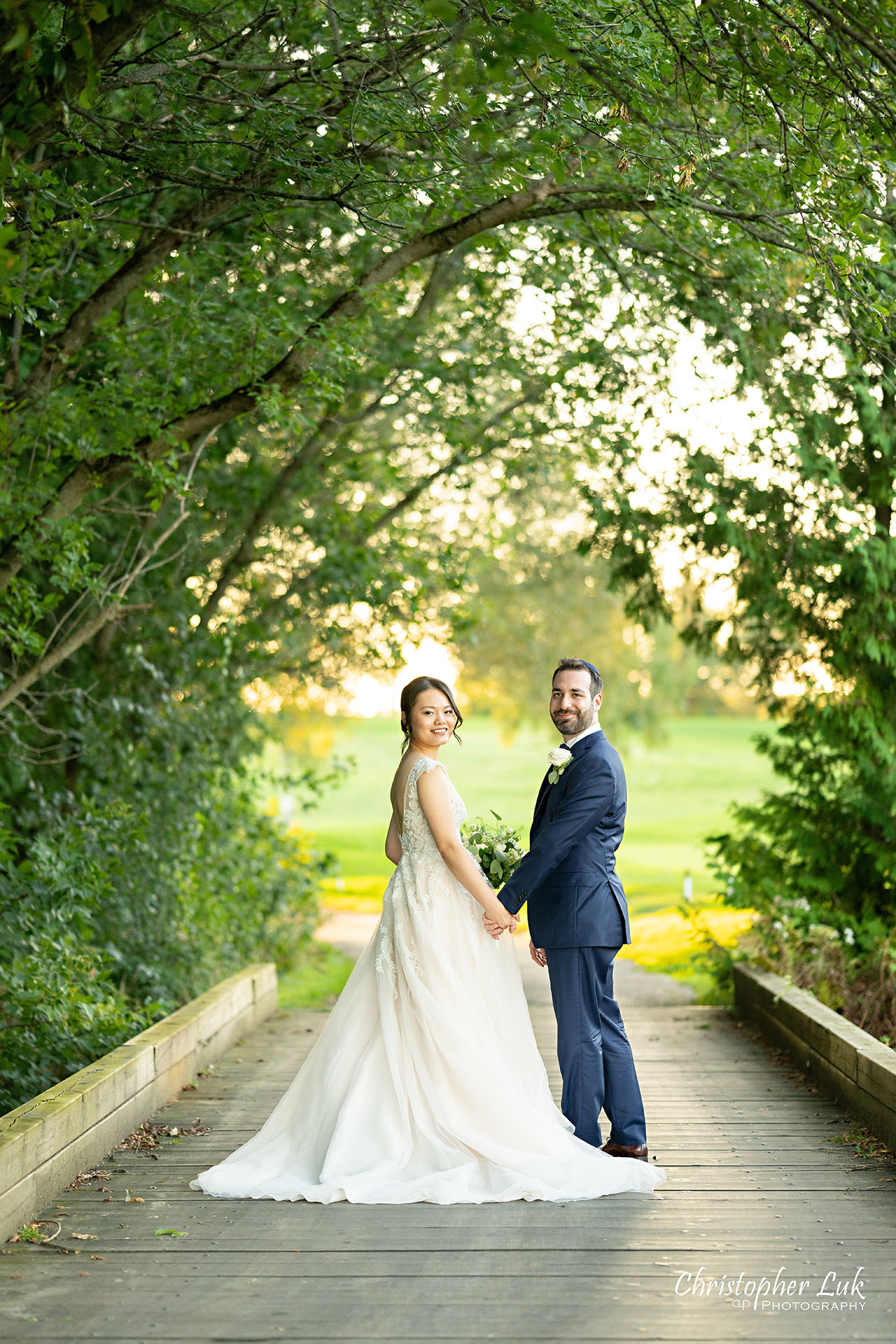 Angus Glen Golf Club Wedding Bride Groom Sunset Golden Hour Boardwalk Tree Canopy Holding Hands Smiling Portrait