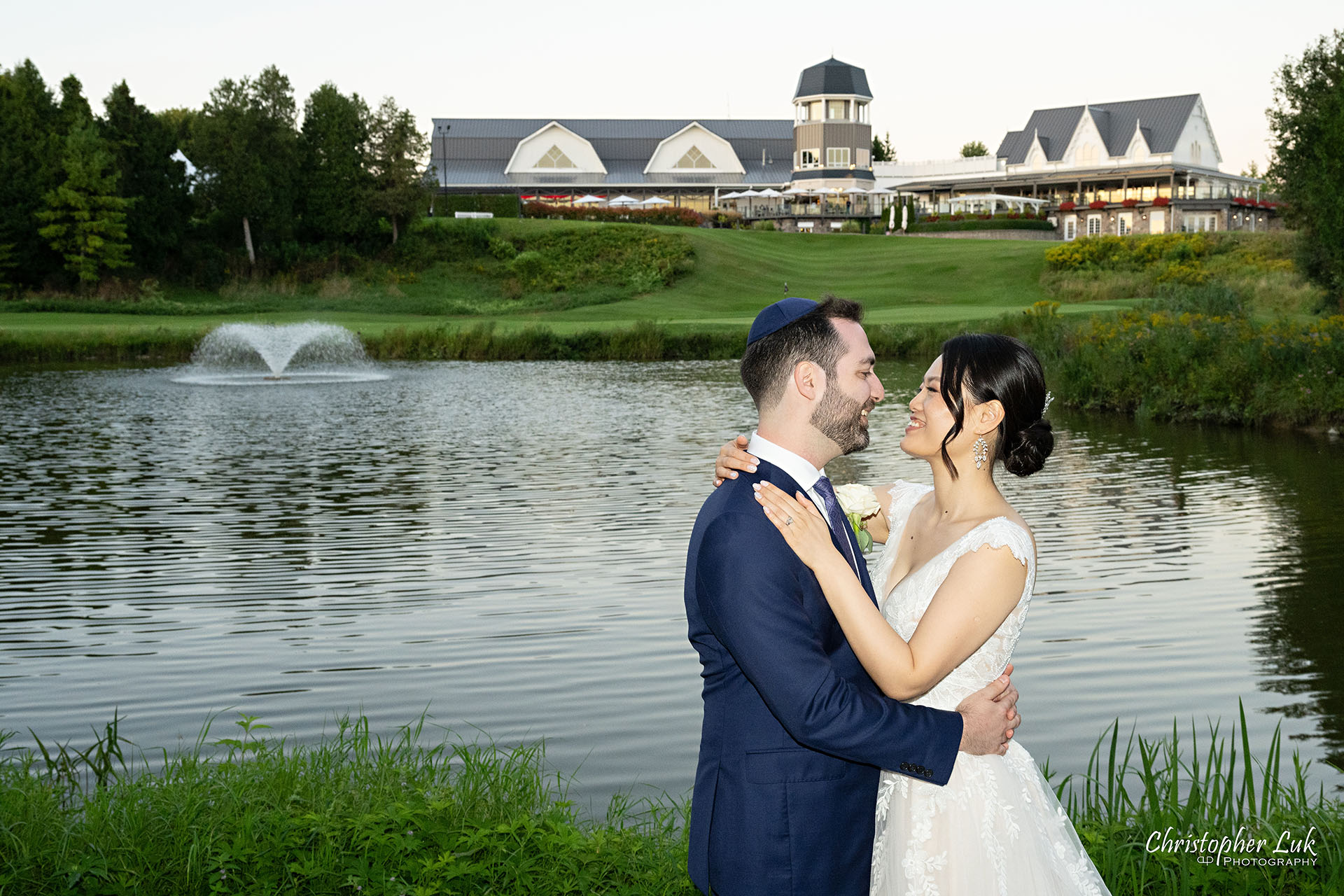 Angus Glen Golf Club Wedding Bride Groom Sunset Golden Hour Hug Intimate Clubhouse Pond Water Fountain Scenic Landscape 