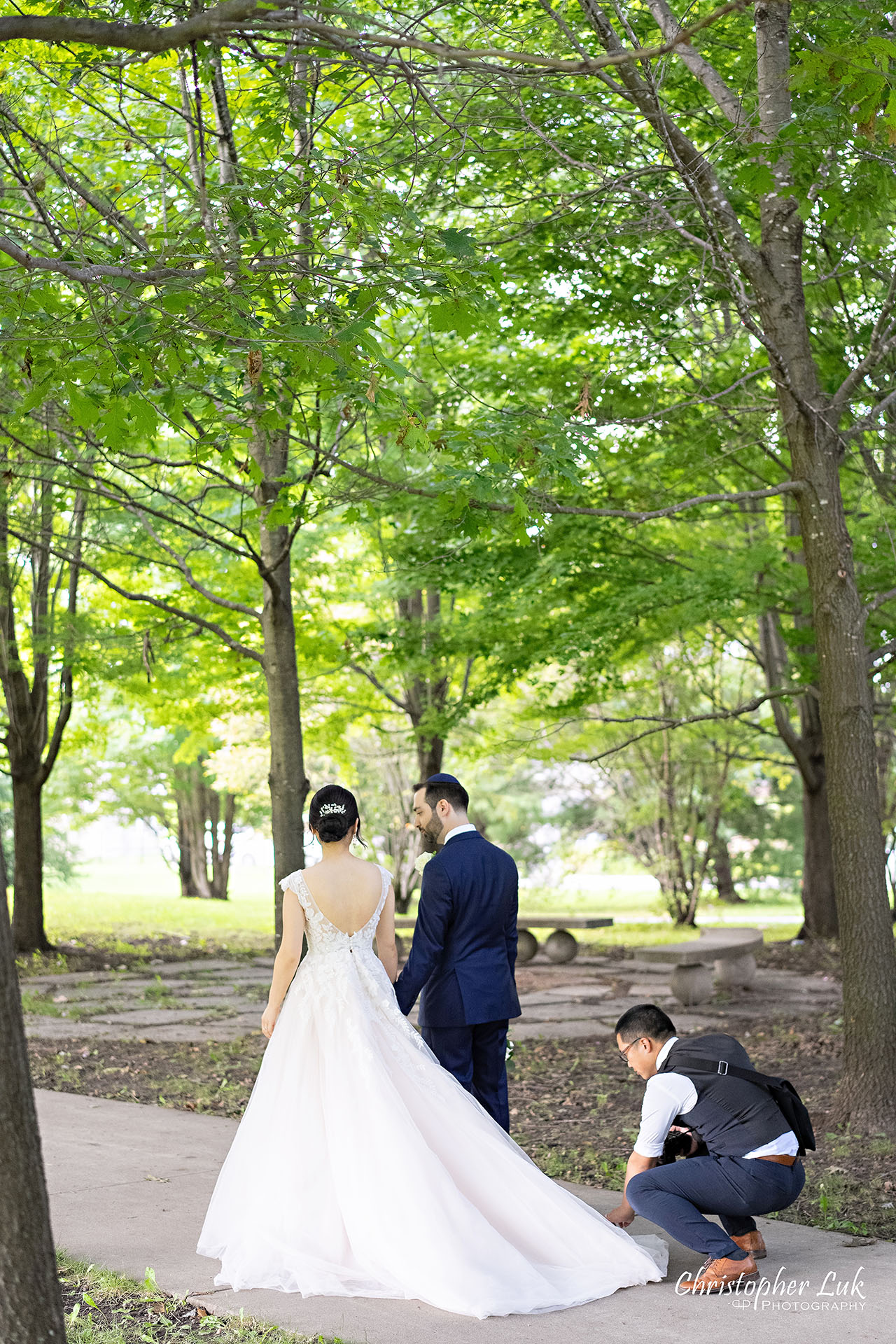 Christopher Luk Toronto Wedding Photographer Behind the Scenes Fixing Bride's Dress Portrait