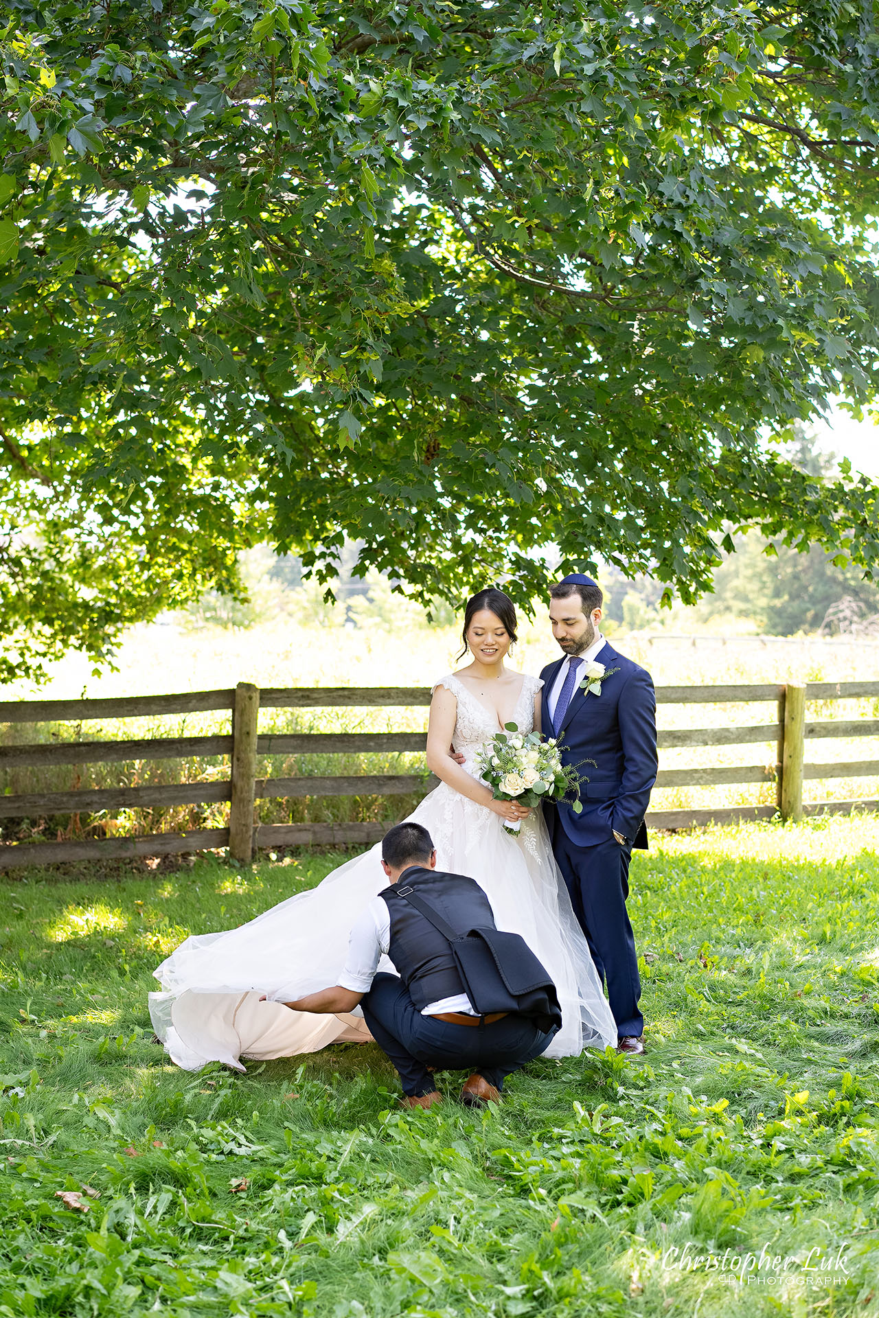 Christopher Luk Toronto Wedding Photographer Behind the Scenes Fixing Bride's Dress Portrait